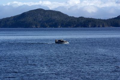 Boat sailing in sea against sky