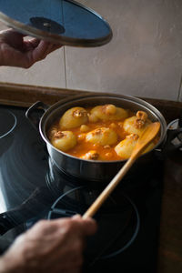 Midsection of person preparing food in kitchen