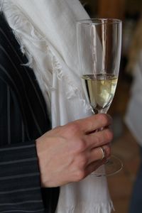 Midsection of woman holding wine glass