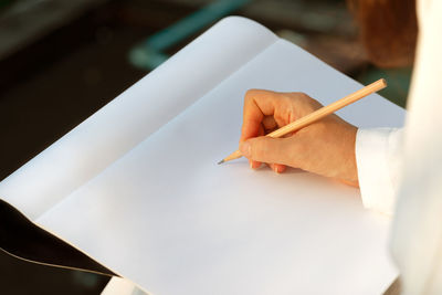 High angle view of man hand on paper