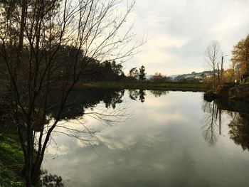 Scenic view of lake against cloudy sky