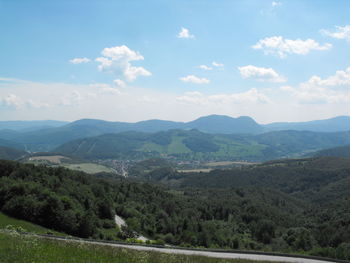 Scenic view of mountains against cloudy sky