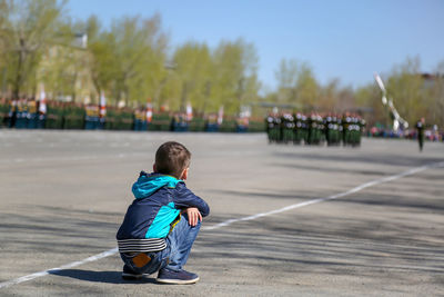 Rear view of boy on road