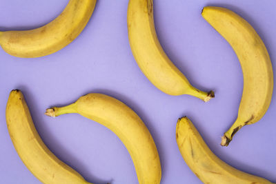 Bananas randomly distributed on purple background