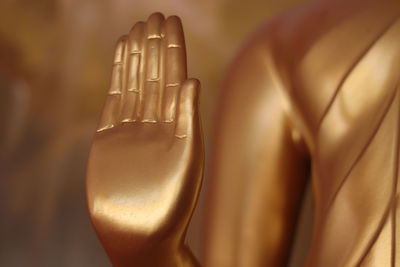 The hands of a golden color buddha statue