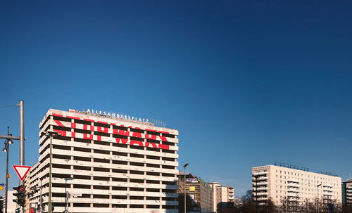 Low angle view of buildings against clear blue sky