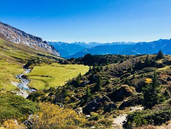 Scenic view of landscape against blue sky