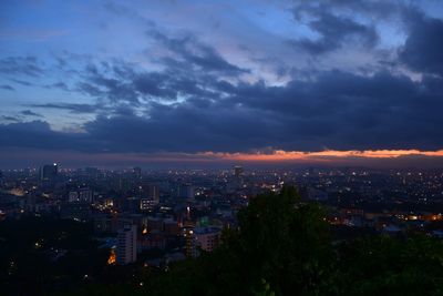 High angle view of illuminated city buildings against sky