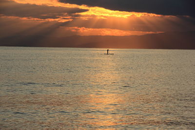 Rafting in calm sea at sunset