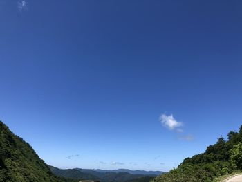 Scenic view of mountains against blue sky