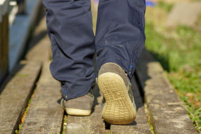 Low section of man walking on footpath