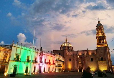 Low angle view of illuminated building against sky