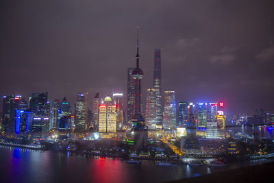 Low angle view of illuminated oriental pearl tower and buildings at night