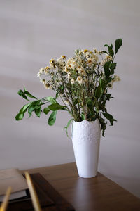 White flower vase on table