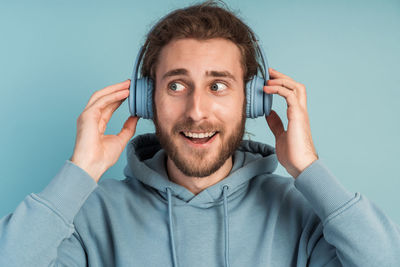 Portrait of smiling man holding smart phone