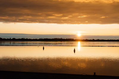 Scenic view of lake against sky during sunset