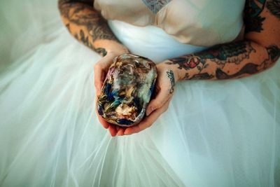 Midsection of woman holding dried flowers