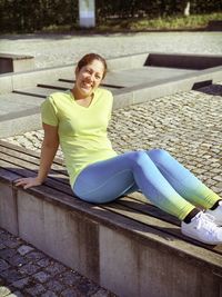 Portrait of a smiling young woman sitting outdoors