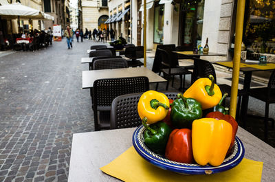 Close-up of bell peppers in plate on table at sidewalk cafe