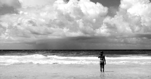 Man standing on beach against sky