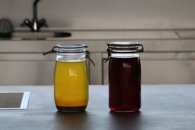 Food in glass jars on table at kitchen