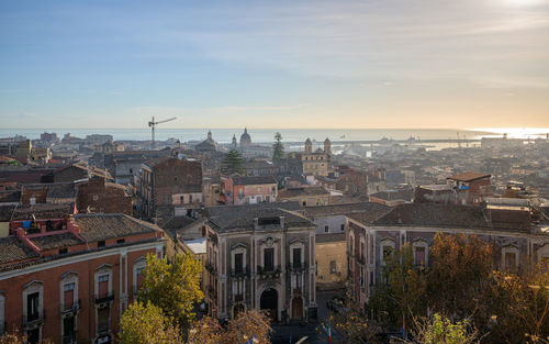 Catania city center, with sant'agata cathedral and medieval town rooftops, sicily, italy, at sunrise