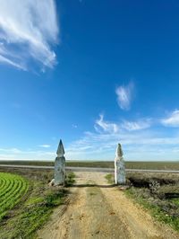 Built structure on field against blue sky