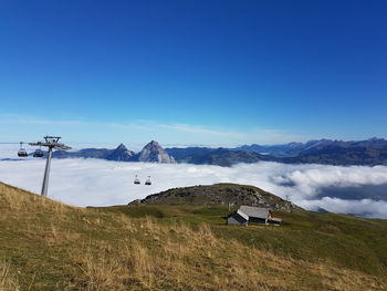 Scenic view of snowcapped mountains against blue sky