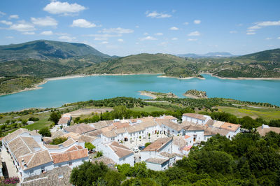 High angle view of townscape by mountains against sky