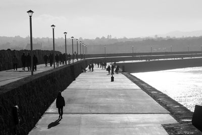 People walking on footpath in city