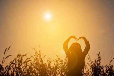 Silhouette of woman at sunset