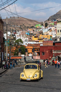 Vehicles on road against buildings in city