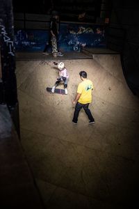 Low section of people walking on soccer field at night