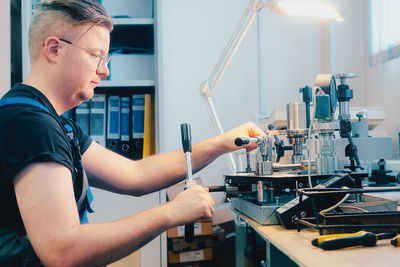 Side view of man working at clinic
