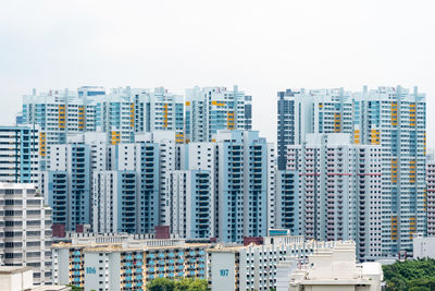 Modern buildings in city against clear sky