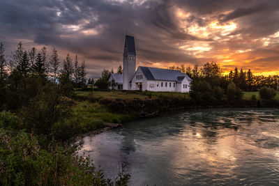 Scenic view of river against sky during sunset