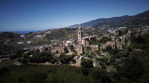 Panoramic view of townscape and mountains against clear sky