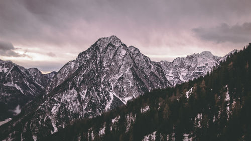 Scenic view of snowcapped mountains against sky during sunset