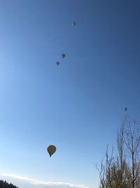 Low angle view of hot air balloon against clear blue sky