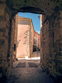 Narrow alley amidst buildings in city