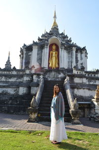 Woman standing against temple
