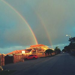 Rainbow over city at night