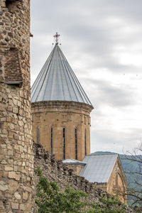 View of old building against cloudy sky