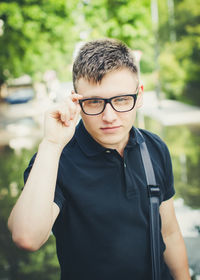 Portrait of young man wearing eyeglasses standing outdoors