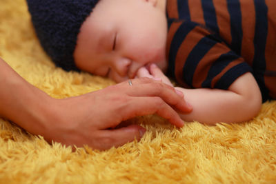 Close-up of baby boy sleeping on bed at home