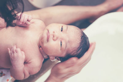 Close-up of baby in bed