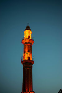 Low angle view of illuminated building against sky at night