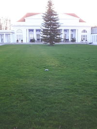 View of soccer field and houses against sky