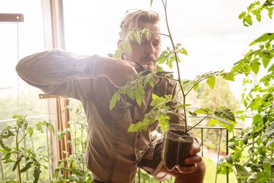 Man holding plants