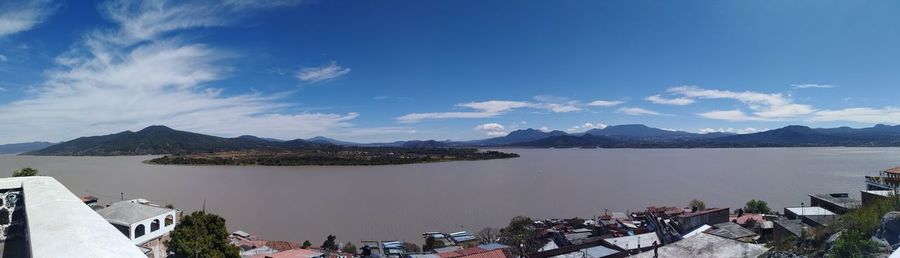 Panoramic view of sea and mountains against sky